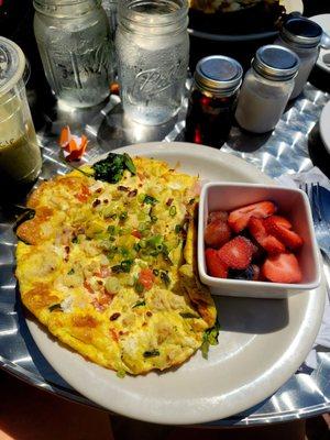 Veggie fritatta with smoked white fish added and side of fruit.