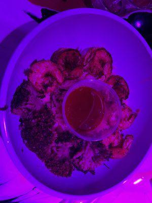 Bowl of rice with side of broccoli and shrimp.