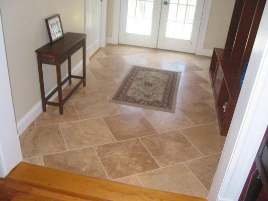 Mudroom creation included dividing master bedroom from mudroom, floor restructuring and travertine flooring.