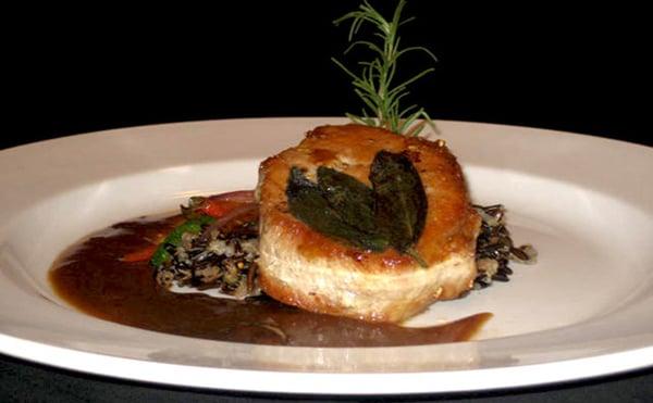 Pan Seared Pork Lion with Fried Sage Leaves, Wild Rice Pilaf, Sauteed Carrots and a Mushroom Demi.