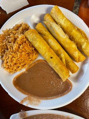 Rolled beef tacos with rice and beans