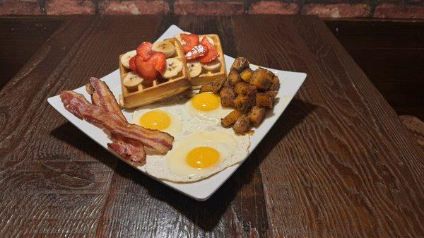 Delicious Belgian waffles strawberry and banana combo 3 eggs bacon homemade potatoes