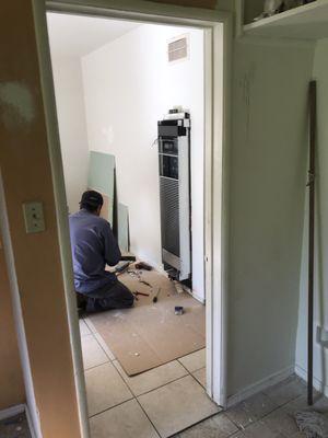 Techs at work on wall furnaces.  Super clean while they work!