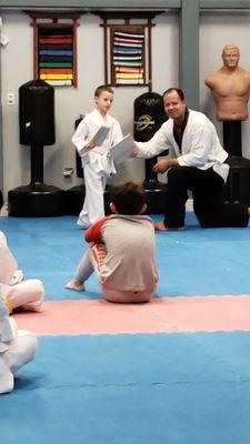 Eli gets his yellow belt from instructor David