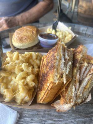 Grilled turkey and cheese sandwich and pulled pork sandwich with mac and cheese.