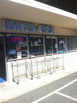 Front of store, carts to get your bottles in and out.