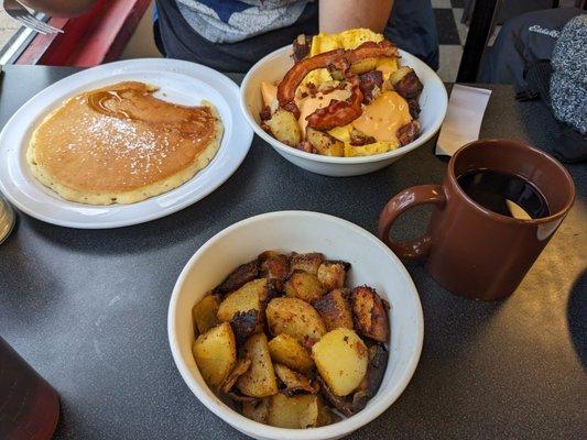 Pancake, side of home fries, coffee, and bowl