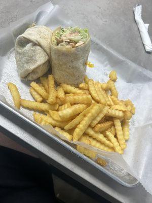 Delicious chicken Cesar wrap with fries!