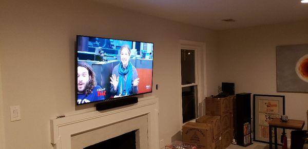 TV and soundbar installed above fireplace George town DC.