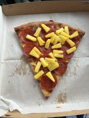 Slice of pepperoni & pineapple pizza