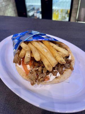 Authentic Greek Gyro - Rotisserie Pork, Homemade Tzatziki Sauce, Onions, Tomatoes, Topped with Seasoned French Fries