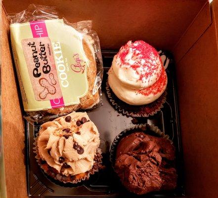 Clockwise: Filled Peanut Butter Cookie, Red Velvet Cupcake, Midnight Magic Cupcake & Chocolate Chip Cookie Dough Cupcake at Gigi's Lexington