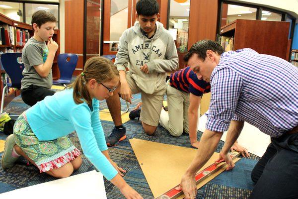 Lower, Middle and Upper School students collaborate to build a geodesic dome.