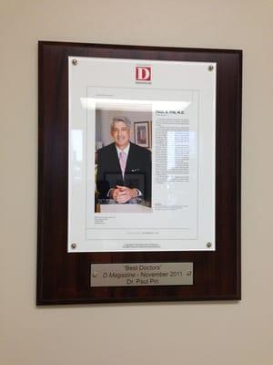 Picture of several of his awards posted around his office.