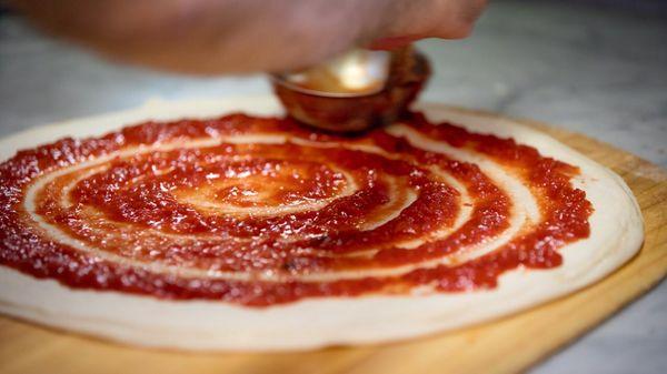 Behind the scenes picture of our hand crafted pizza in the making.
 Photographer: Justin Huard