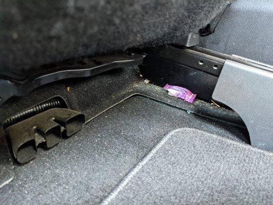 under driver seat, easily removed/vacuumed