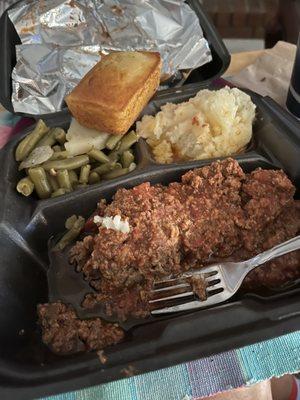 Meatloaf w/green beans n mashed potatoes. Loaf of cornbread.