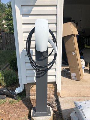 Tesla Charger (EV Charger) on Pedestal in driveway.