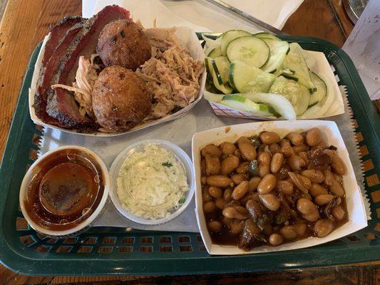 Brisket, pulled pork, baked beans, cukes, slaw, hush puppies.