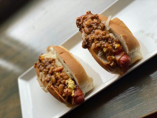 Bacon wrapped hot dogs with homemade chili and sauerkraut.