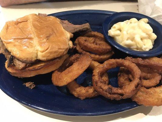 Brisket dinner sandwich with onion rings and Mac n cheese