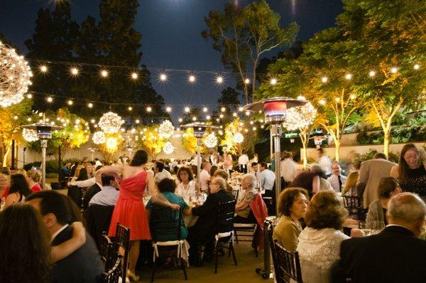 Have our team uplight the trees and hang lights overhead to illuminate your special occasion.  - At Mountaingate Country Club