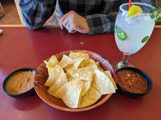 Chips, bean dip, salsa, and jalapeno margarita