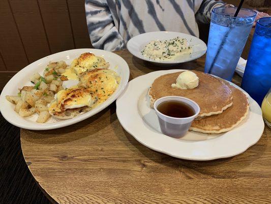 "3" Point Conversion Benedict with potatoes, side of biscuits and gravy, and a side of pancakes.