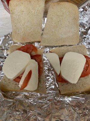 Tomato, mozzarella, basil, pesto sandwich.