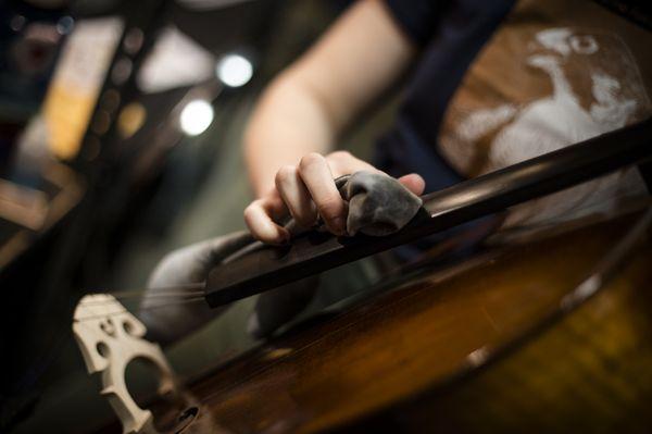 Polishing and cleaning a cello.