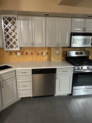 The kitchen after the installation of the countertops and cabinets were painted