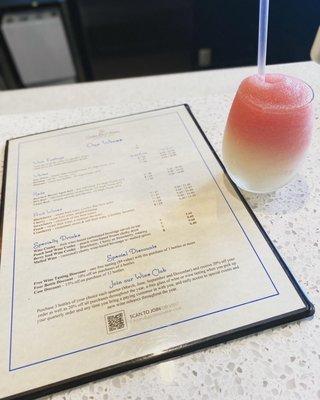 Swirled peach and berry wine cooler with the drink menu