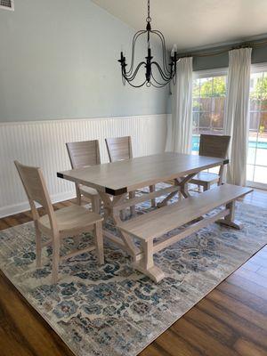 solid wood dining table with chairs and a bench