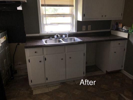 New countertops, hardware, stripped, sanded, and painted cabinets.