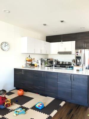 Adding two cabinets and the doors to an existing open bookshelf under the kitchen counter.