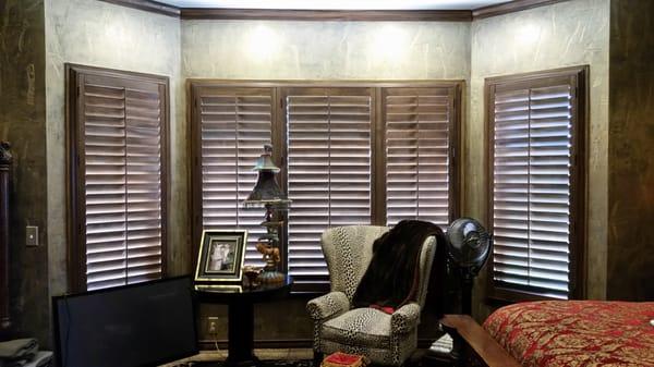 Stained wood shutters with four sided deco frame.