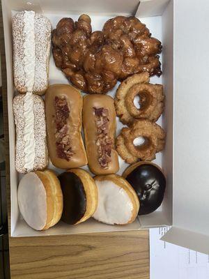 Apple fritters, bismarks, lady fingers cake donuts.