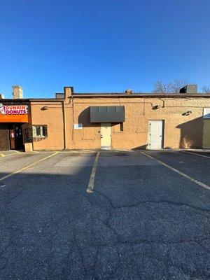 The parking lot & back of the brick building of Hanley Sound currently occupied by Dunkin' Donuts in Medford MA.