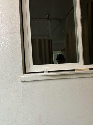 Photo of the window not even secure or finished letting bugs in could just fall onto the patient