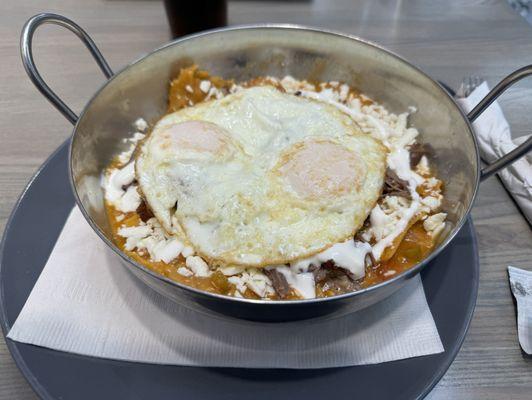 Chilaquiles with red sauce and beef.