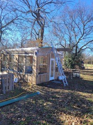 Installing metal roofing for this customers green planting house.