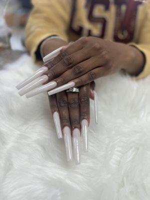 Extremely long nails with off white powder.