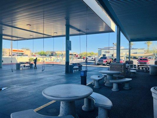 outside waiting area with tables and shade