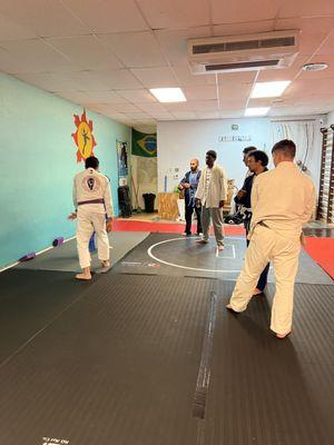 Coach Esteban shows the technique of the day and students get a chance to practice their reps.