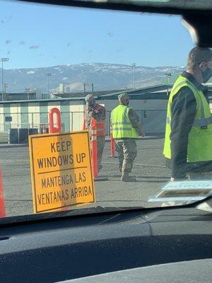 Camo guy w/orange vest pulling up his mask wasn't wearing it at first. He put it on after seeing me looking at him.