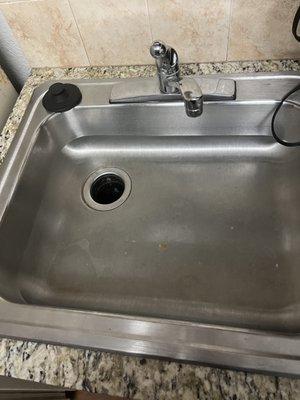 Filthy sink w dry crud stuck in it