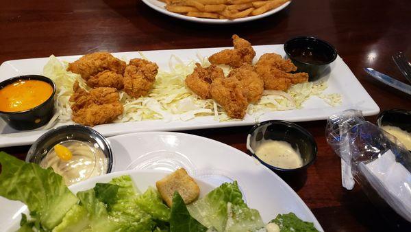 Firecracker shrimp appetizer with sauce on the side.