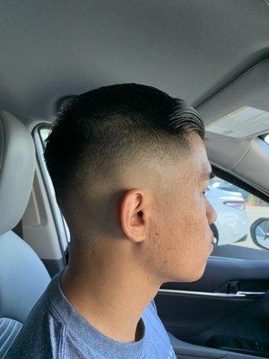 Medium skin fade with scissor trim on top