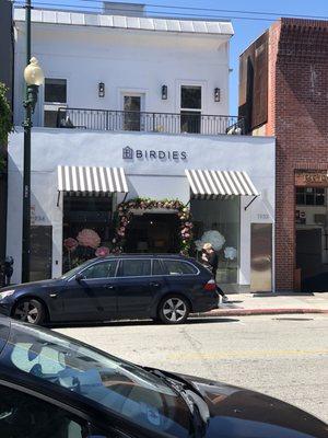 The storefront is decorated in peonies and other flowers