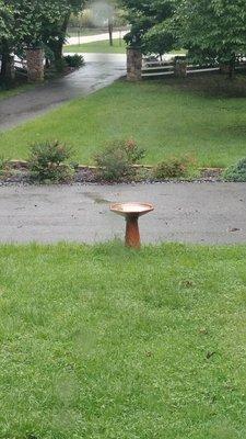 Glazed ceramic bird bath on a ceramic base.